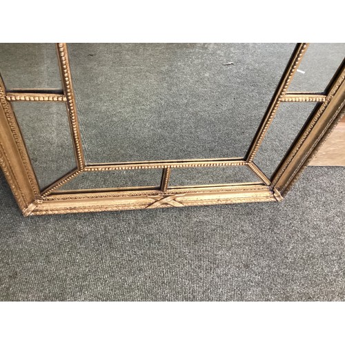 668 - A late Georgian gilt framed rectangular wall mirror with ribbon and bead ornament and mirrored borde... 