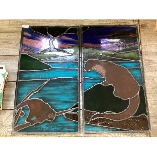 354 - Two lead lined stained glass panels, one with a decoration of an  otter and one with deer, approx si... 