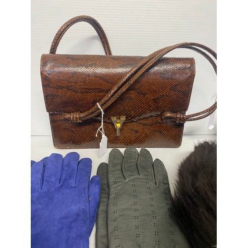 282 - A vintage brown leather handbag, and a quantity of silk scarves, ties, gloves,  a 1970’s sheepskin w... 