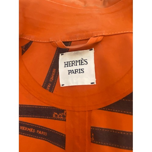 296 - A vintage HERMES, PARIS, mackintosh, with the iconic fastenings and printed branding to inside, cond... 