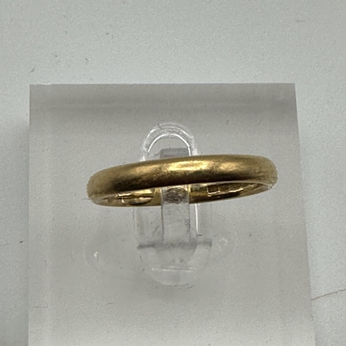 21 - A 22ct gold wedding band. Size P. 4.20g.