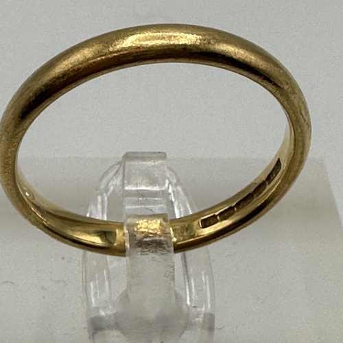 21 - A 22ct gold wedding band. Size P. 4.20g.