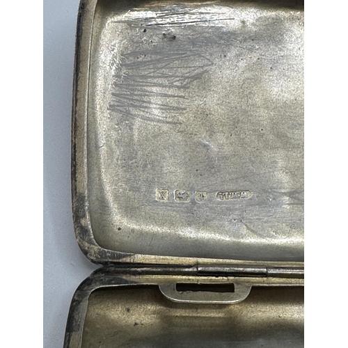 28 - A sterling silver hip shaped cigarette case together with a white metal sovereign holder and vesta i... 