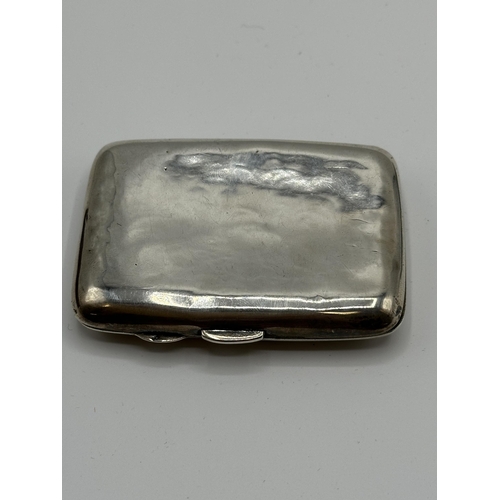 28 - A sterling silver hip shaped cigarette case together with a white metal sovereign holder and vesta i... 