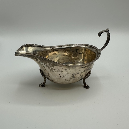 64 - A sterling silver sauce boat by AE Poston & Co. Birmingham 1936 together with a silver mustard and w... 