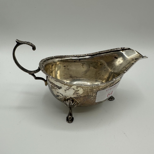 64 - A sterling silver sauce boat by AE Poston & Co. Birmingham 1936 together with a silver mustard and w... 