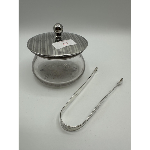 67 - A collection of sterling silver items to include sugar tongs flatware and silver topped glass items.... 