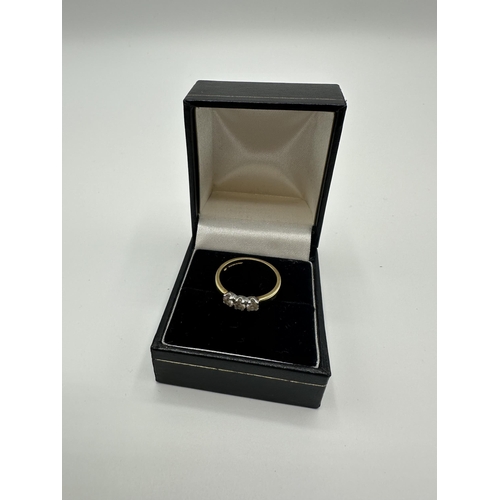 80 - An 18ct gold three stone diamond ring. size N. 3.9g.