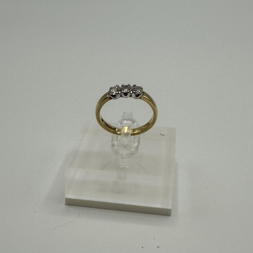 80 - An 18ct gold three stone diamond ring. size N. 3.9g.