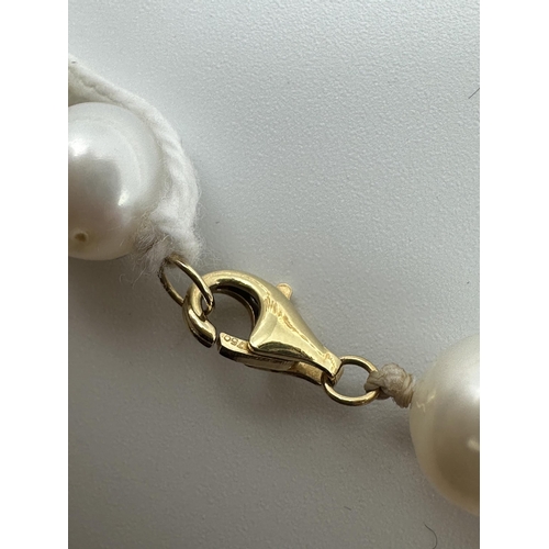 9 - A strand of large uniform pearls with 18ct gold clasp. approx 13mm pearls. 45cm.