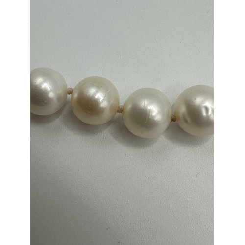 9 - A strand of large uniform pearls with 18ct gold clasp. approx 13mm pearls. 45cm.