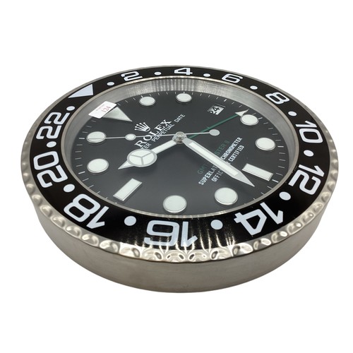 124 - A Rolex Oyster perpetual GMT Master II wall clock. 34cm