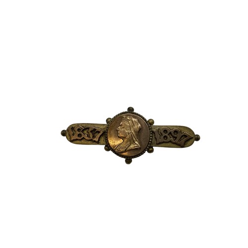 135 - An unmarked yellow metal cameo ring together with an Etruscan style yellow metal brooch.