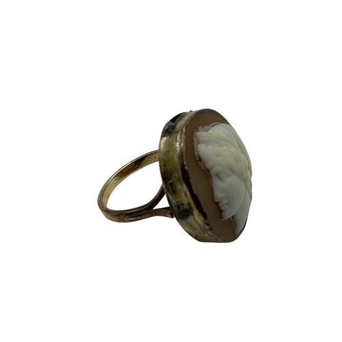 135 - An unmarked yellow metal cameo ring together with an Etruscan style yellow metal brooch.