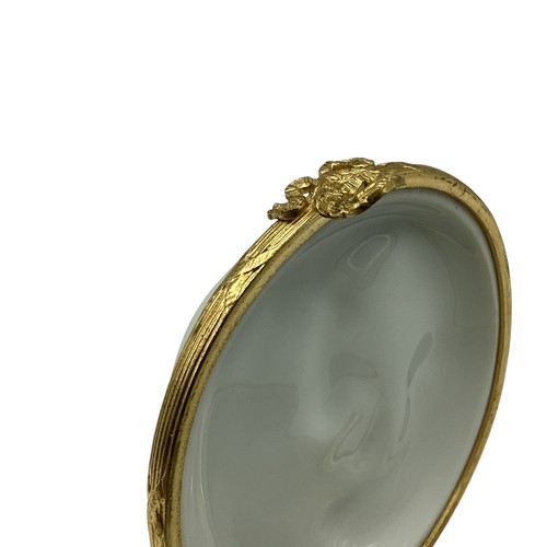 140 - A Limoges, porcelain and gilt metal circular box with raised classical scene 8cm(d)