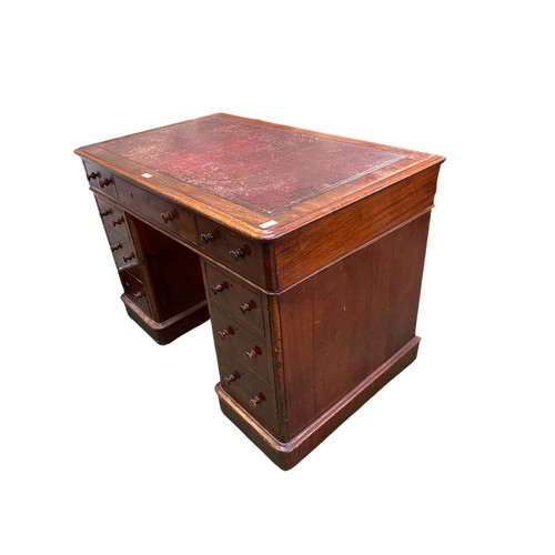 654 - Small Victorian twin pedestal mahogany writing desk of 9 drawers below a tooled leather top.  66 cm ... 