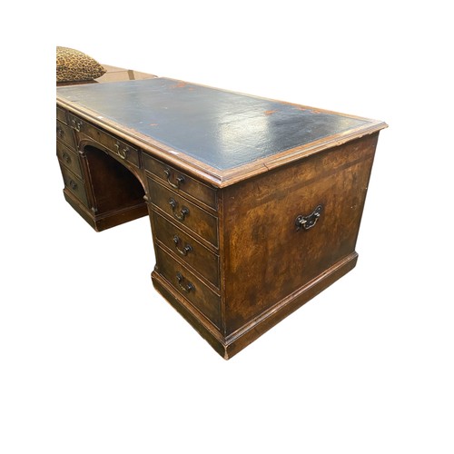 618 - Large walnut kneehole writing desk of 9 drawers, the solid polished ends with carrying handles, bene... 