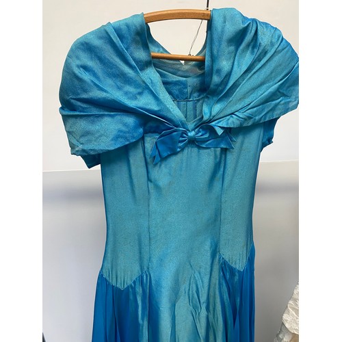 234 - A 1950s turquoise dance dress, fully lined with interlined skirt. Bodice has a bow trim to a portrai... 