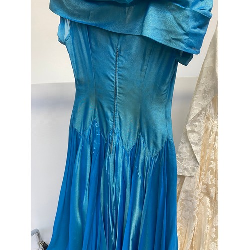 234 - A 1950s turquoise dance dress, fully lined with interlined skirt. Bodice has a bow trim to a portrai... 