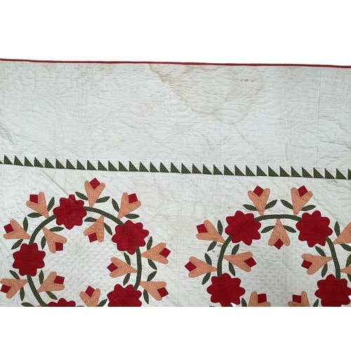 155 - Two American quilts, one with all over red and orange floral pattern, with some stains 230 x 236cm, ... 