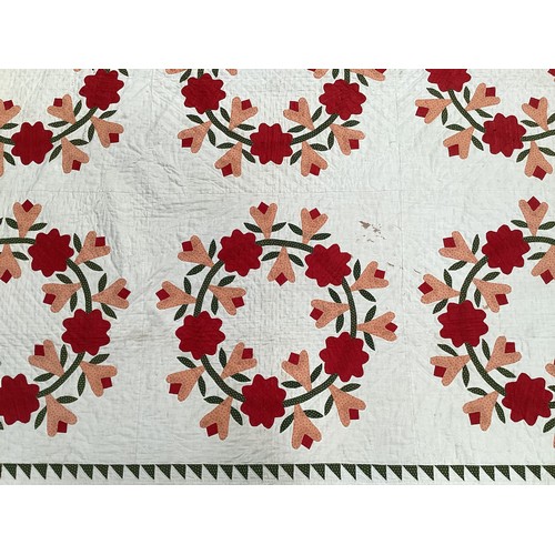 155 - Two American quilts, one with all over red and orange floral pattern, with some stains 230 x 236cm, ... 