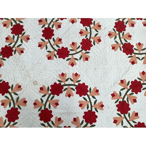 155 - Two American quilts, one with all over red and orange floral pattern, with some stains 230 x 236cm, ... 