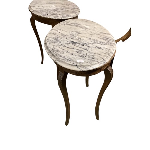 561 - A pair of side tables, with oval tops of white and black veined marble, and the base of carved wood ... 