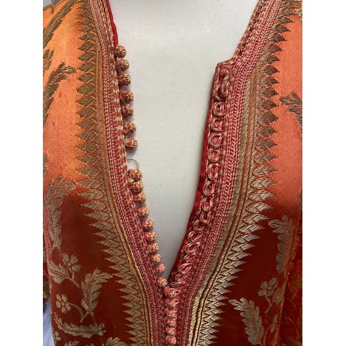 228 - A orange silk and gold coloured thread Kaftan, purchased in Marrakech in 1964, condition, some minor... 