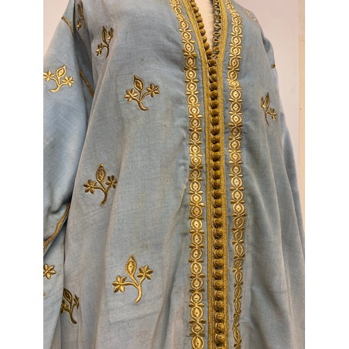 226 - A blue velvet antique wedding Kaftan, embroidered in gold coloured thread, and purchased in Marrakec... 