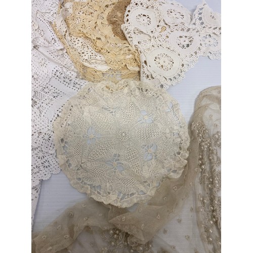 169 - A quantity of antique and later lace, one piece with pearl coloured bead work, as found with some we... 