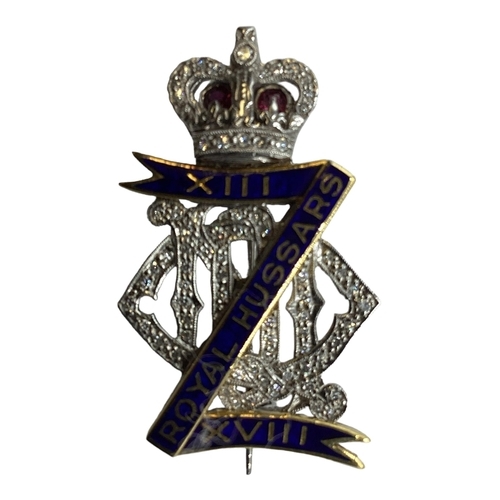 74 - An 18ct white gold diamond ruby and enamel regimental sweethearts brooch for Royal Hussars, set thro... 