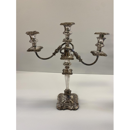 76 - Set of three silver plated table candelabra, central four branch with central holder with finial tog... 