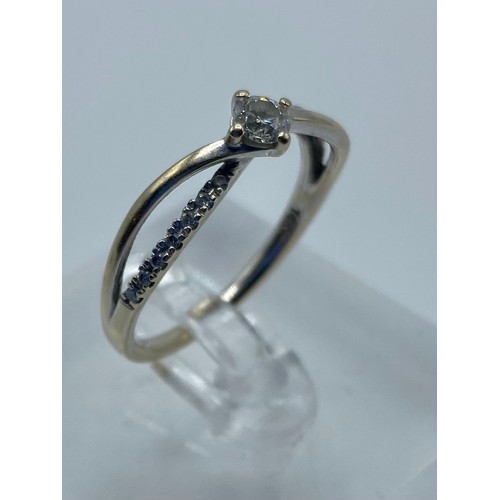 63 - An 18ct gold 0.38ct diamond solitaire with single cut diamond accents  2.6g size N