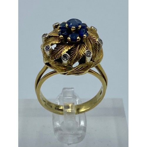 64 - A 14ct gold sapphire and diamond dress ring. Central circular  free cut sapphire with a surround of ... 