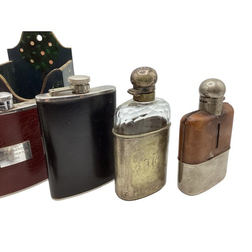 21 - A collection of hip and hunting flasks to include a sterling silver and snake skin example. Sheffiel... 