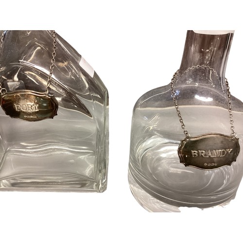 13 - Two glass decanters with sterling silver labels and silver plated items.