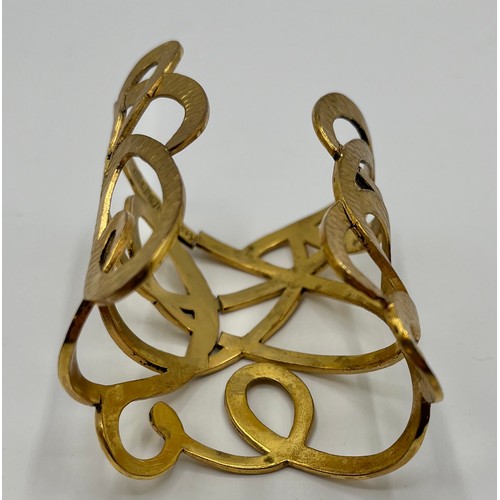 3 - A gilt metal Vintage cuff bracelet by Yves Saint Laurent. Provenance: Formerly the property of a Cou... 