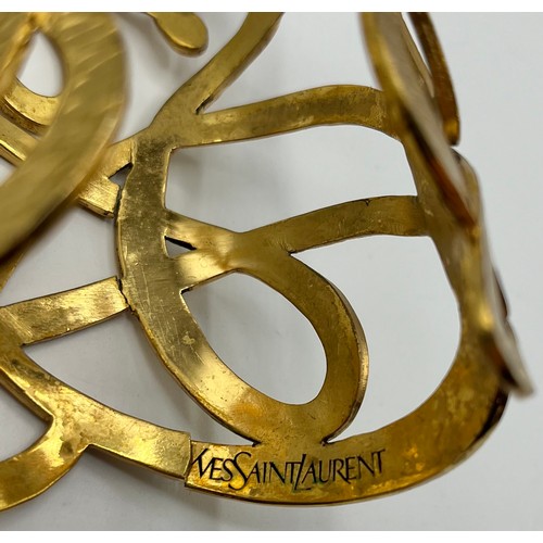 3 - A gilt metal Vintage cuff bracelet by Yves Saint Laurent. Provenance: Formerly the property of a Cou... 