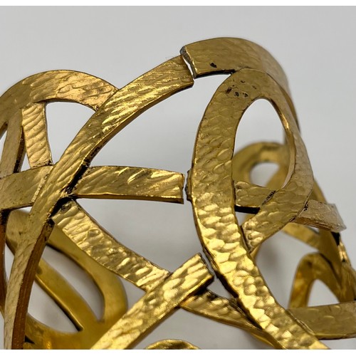 3 - A gilt metal Vintage cuff bracelet by Yves Saint Laurent. Provenance: Formerly the property of a Cou... 