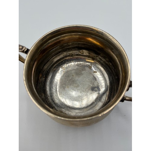 28 - A sterling silver sugar bowl of heavy gauge with stylised mermaid loop handles by William Hutton and... 