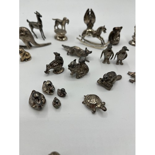 7 - A collection of sterling silver miniature items. Mostly cast animals with with  a Lincoln imp , rock... 