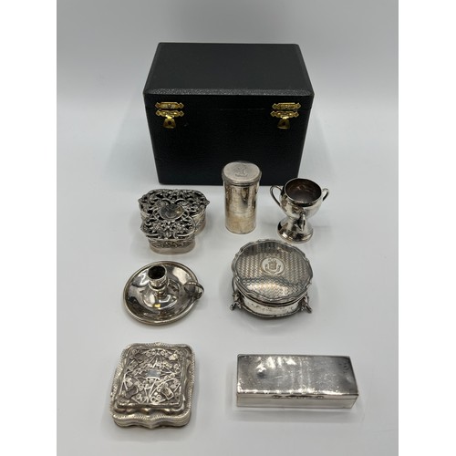 10 - A collection of sterling silver bijouterie items to include pierced boxes, a small go to bed a troph... 