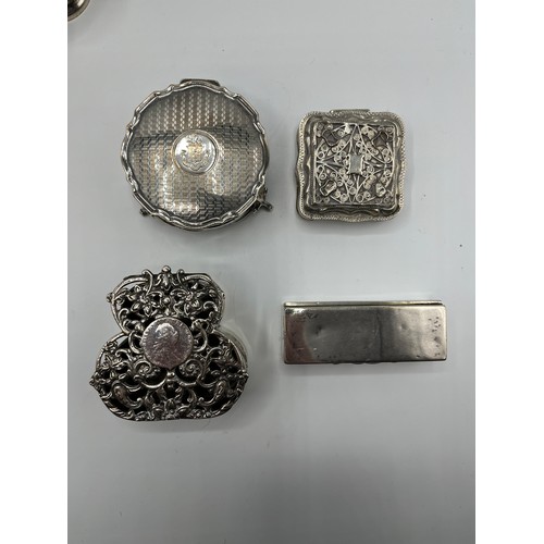 10 - A collection of sterling silver bijouterie items to include pierced boxes, a small go to bed a troph... 