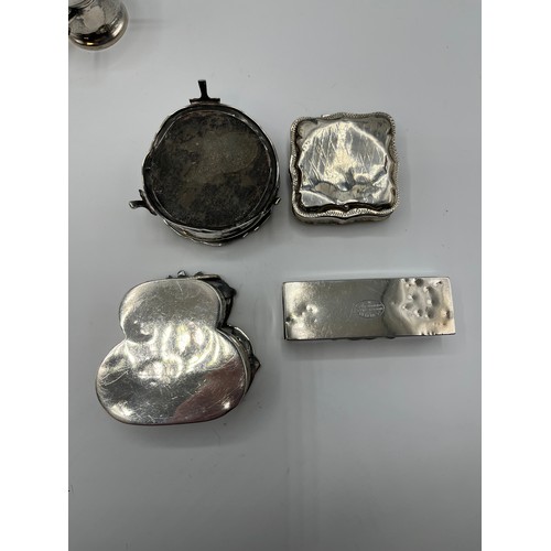 10 - A collection of sterling silver bijouterie items to include pierced boxes, a small go to bed a troph... 