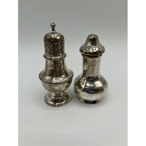 15 - A collection of sterling silver items to include a Georgian sugar sifter, toast rack, pepperettes et... 