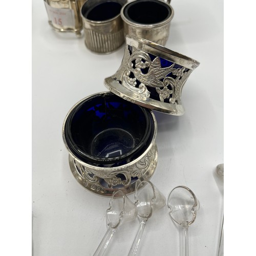 15 - A collection of sterling silver items to include a Georgian sugar sifter, toast rack, pepperettes et... 