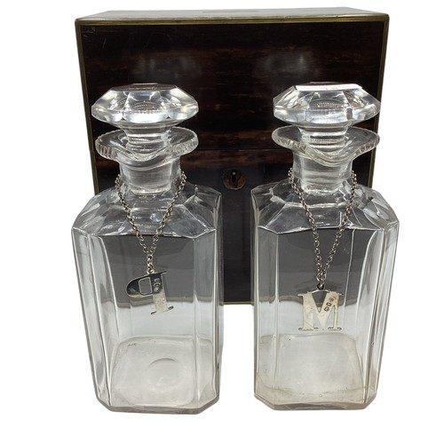 18 - A coromandel cased two bottle decanter set with sterling silver labels together with a boxed writing... 