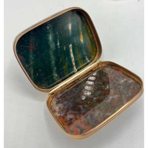 81 - An unmarked yellow metal snuff set with hardstone panels together with a similar oval unmarked white... 