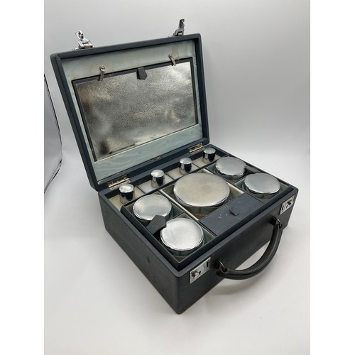 84 - Asprey London . A mid 20th century faux leather ladies dressing table travel case. Complete with ful... 