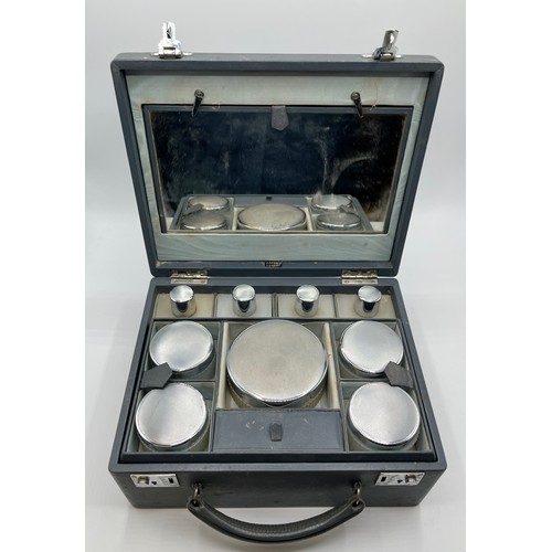 84 - Asprey London . A mid 20th century faux leather ladies dressing table travel case. Complete with ful... 